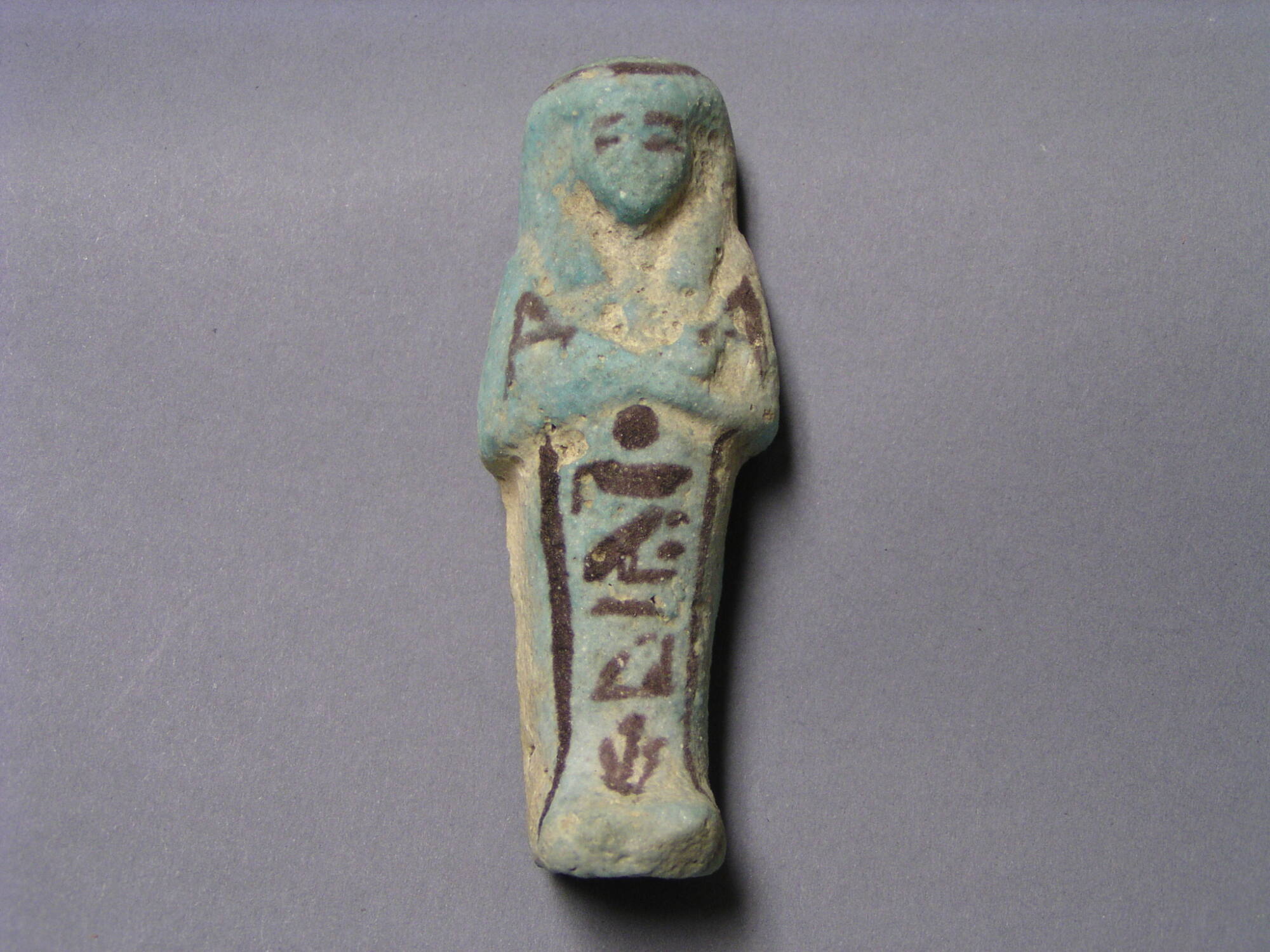 Blue shabti with black decorations